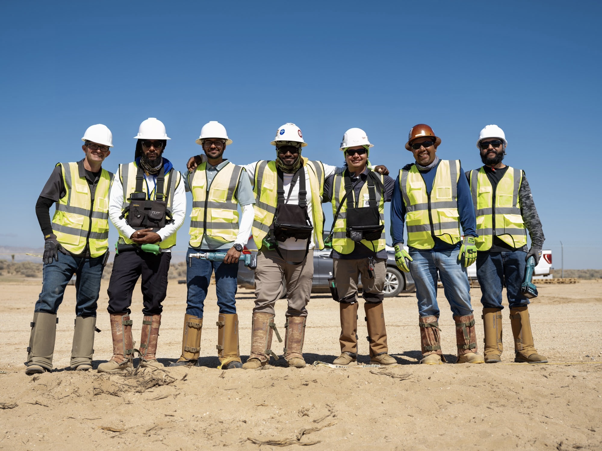 Maximo crew members in hardhats and safety vests at a utility-scale solar project site